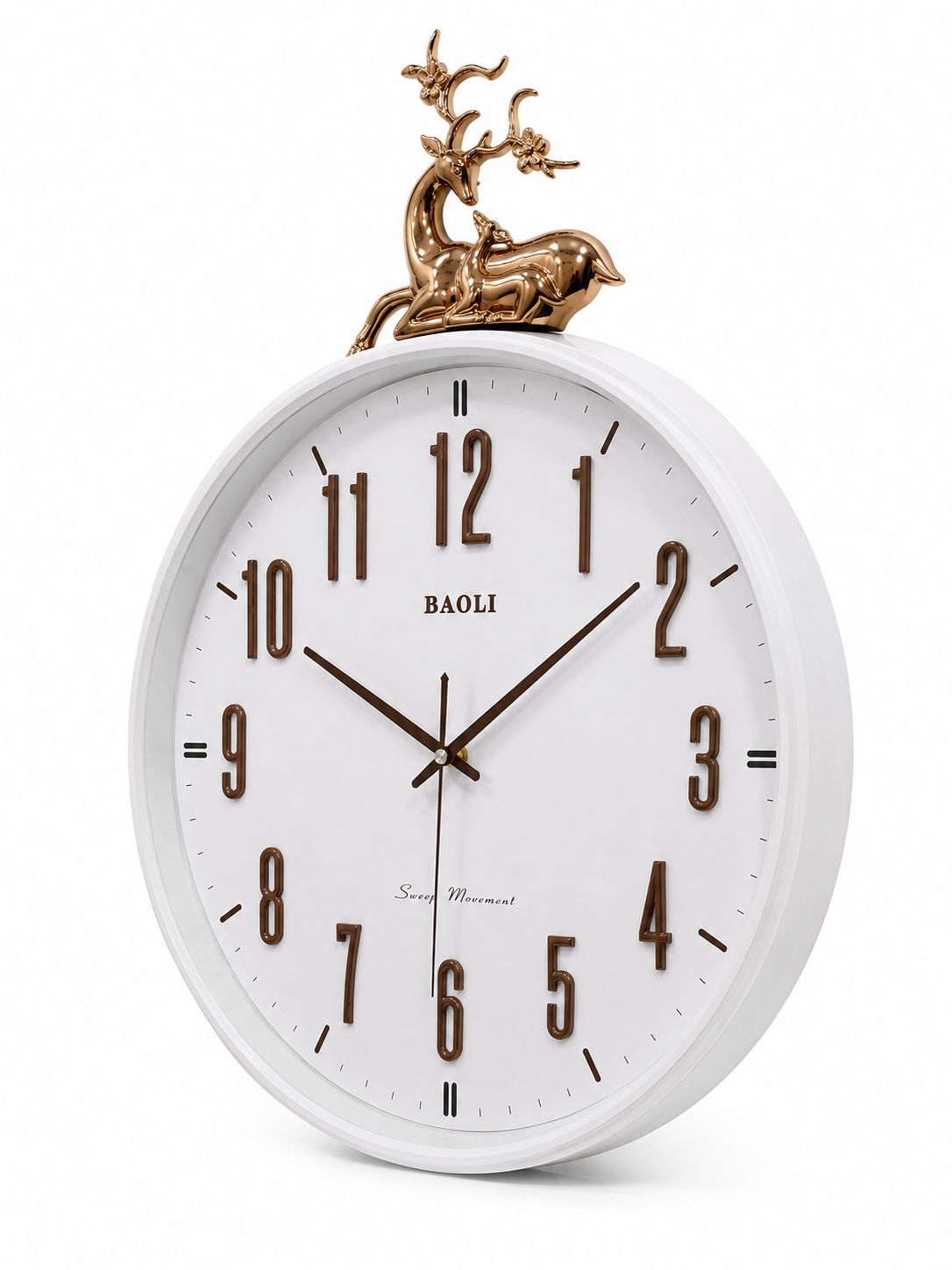 A white round wall clock with dark brown Arabic numerals and hands, featuring a decorative bronze deer figurine on top, shown against a plain white background.