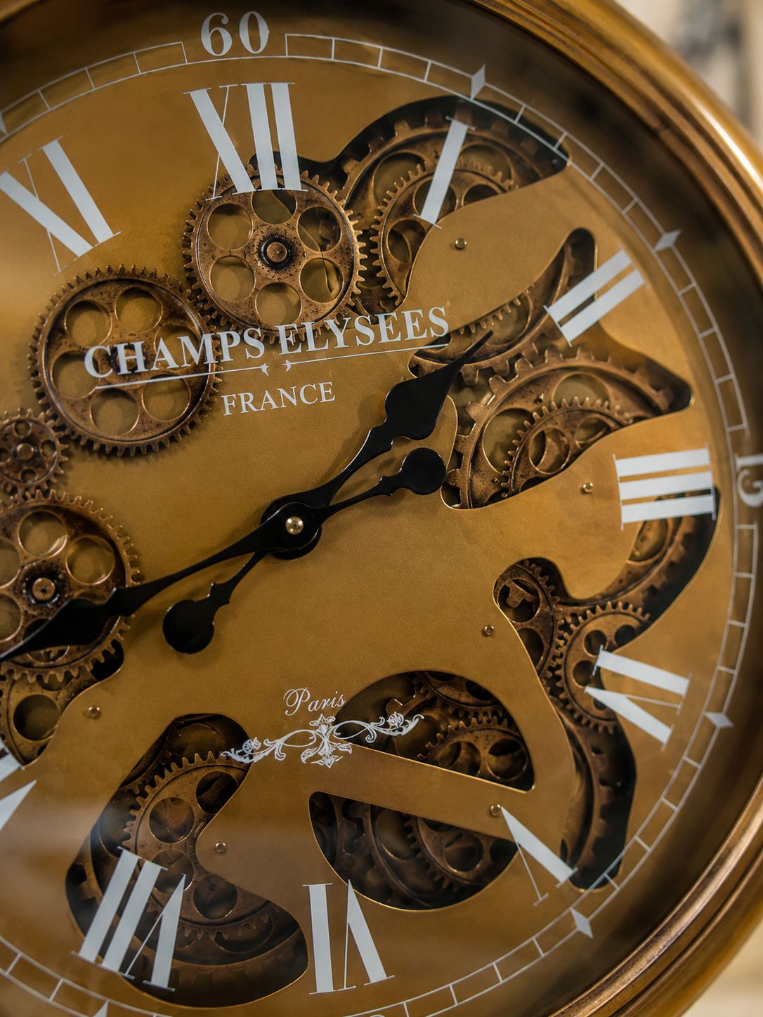 Close-up of a gold clock face with visible gears and &