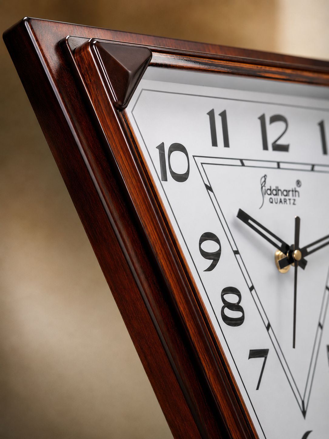 Close-up of a wooden wall clock showing a white face with black numerals and black hands, with a warm brown wood frame and a blurred beige background.