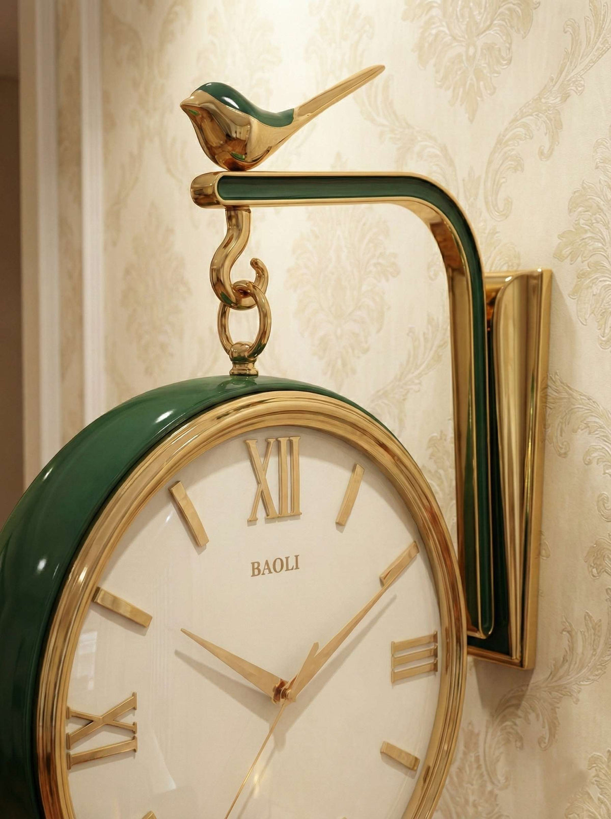 Decorative wall clock with green and gold design on a patterned wall.