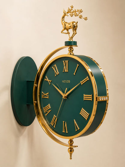 A decorative wall clock with a dark green face and matching green wall mount, framed in gold-tone metal. The clock features gold Roman numerals, ornate gold hands, a gold decorative branch with a deer topper, and curved gold support bars.