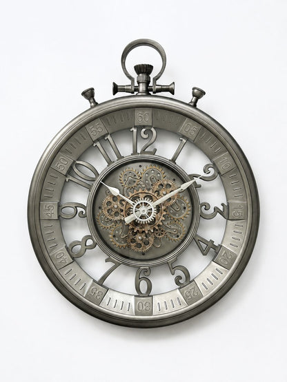 A round skeleton pocket watch with a metallic gray steel casing, featuring exposed internal gears and clockwork at the center, set against a plain white background.