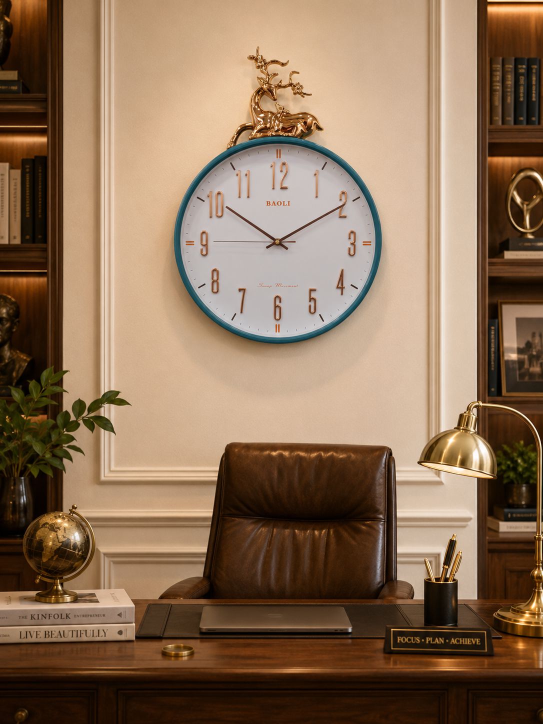 A round wall clock with a white face, blue rim, and gold decorative deer figure on top, mounted on a cream wall above a dark brown leather office chair and wooden desk.