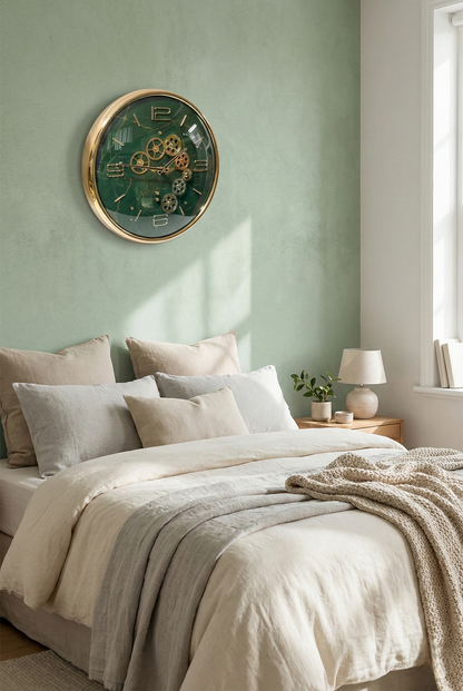 Bedroom with a large wall clock on a light green wall, bed with pillows and blankets, and a lamp on a nightstand.