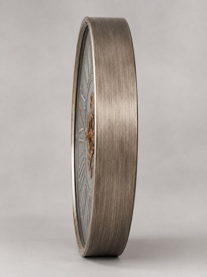 Bronze-colored circular object with detailed design on a gray background