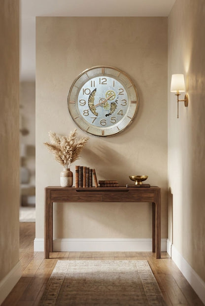Decorative clock on a wall above a wooden console table with books and decor items.