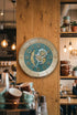 Decorative clock on a wooden wall in a cozy cafe setting