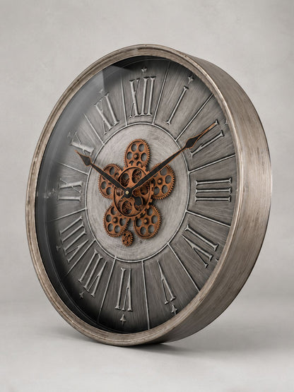 Decorative clock with metallic finish and gear design on a gray background