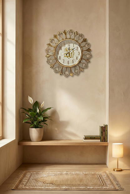 Decorative wall clock on a beige wall with a plant and books below.