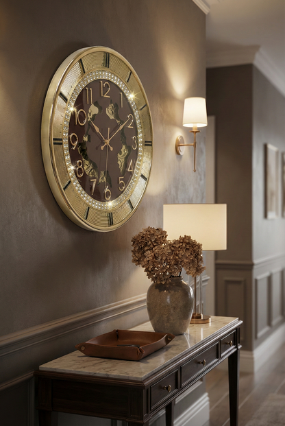 Decorative wall clock on a wall with a lamp and vase on a table below.