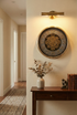 Decorative wall clock with gear design on a wall above a wooden console table.