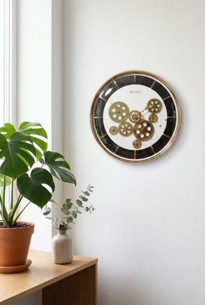 Decorative wall clock with gear design on a white wall next to a plant.