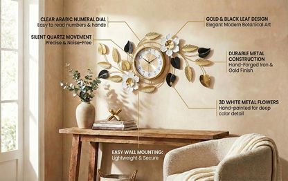 Decorative wall clock with gold and black leaf design on a wall with a table and chair.