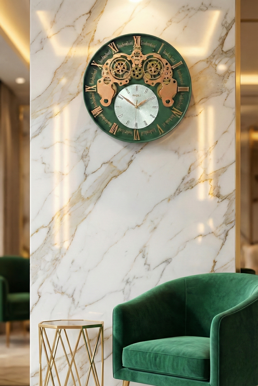 Decorative wall clock with gold and green design on a marble wall, with a green armchair and gold side table in the foreground.
