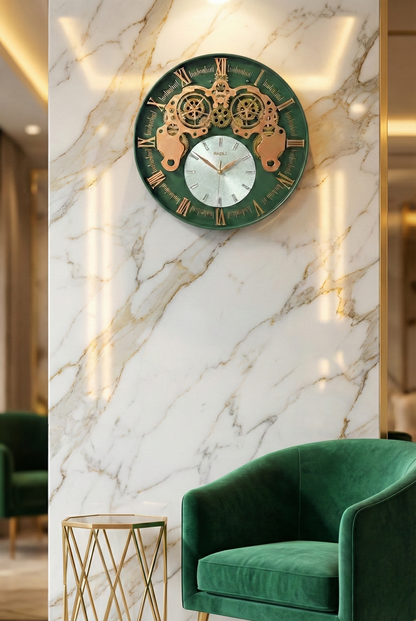 Decorative wall clock with gold and green design on a marble wall, with a green armchair and gold side table in the foreground.