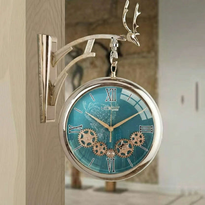 Decorative wall clock with turquoise face and gold gears on a wooden surface.