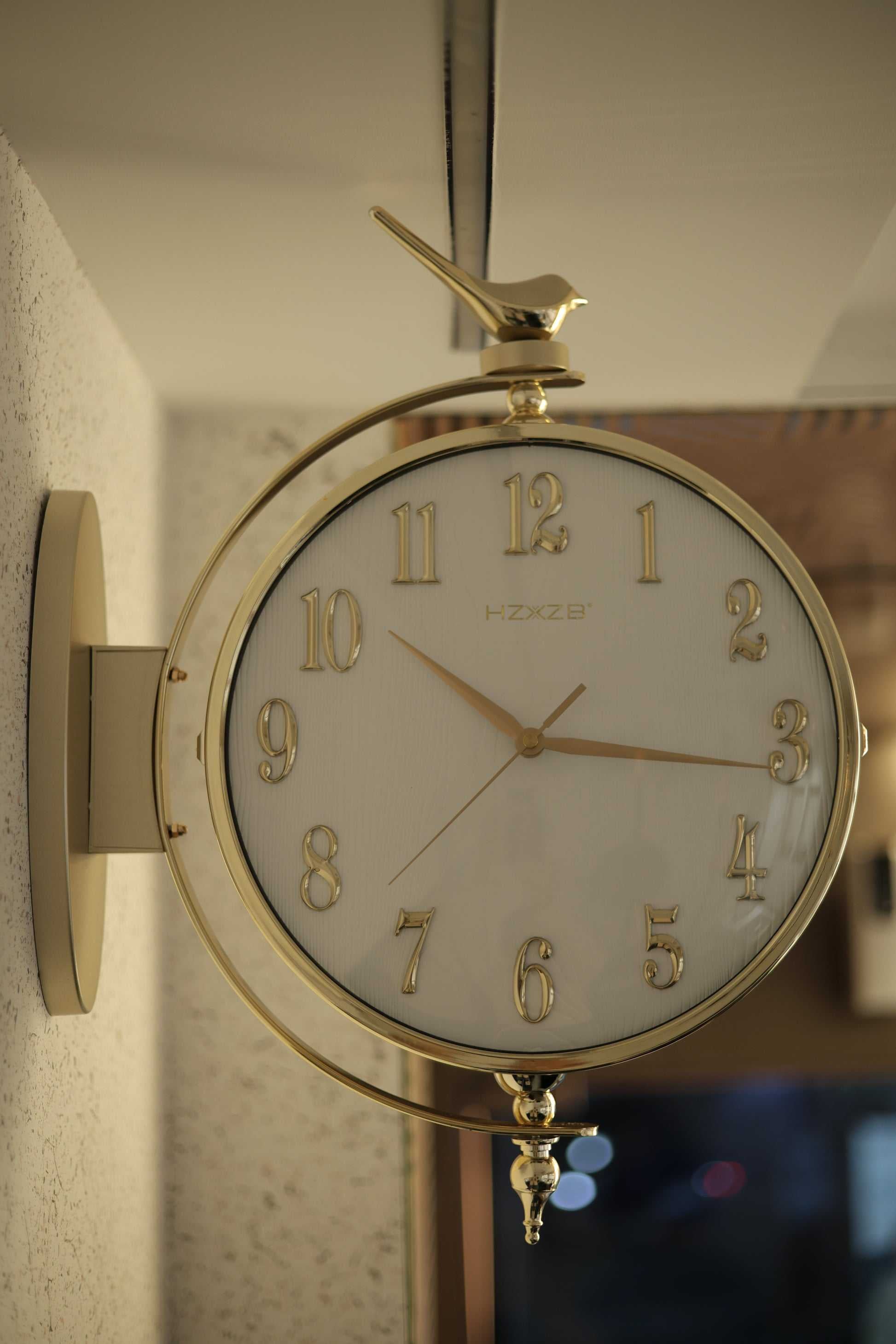 Double-sided deer wall clock mounted in modern living room