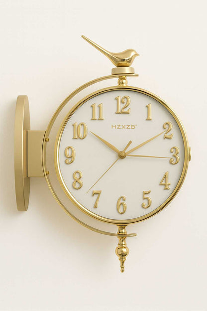 Gold wall clock with bird design on a white background