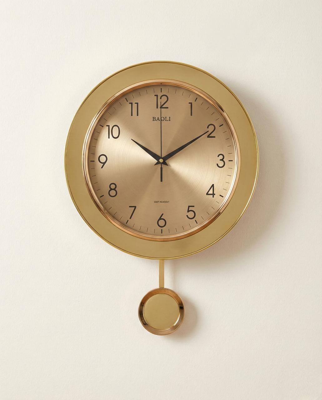 Gold wall clock with pendulum on a white background
