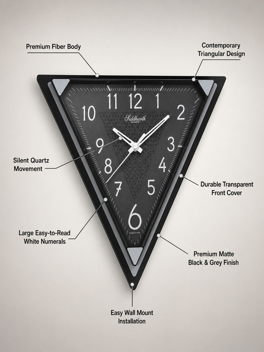 A triangular black wall clock with white numerals and hands, shown on a light gray background with callout lines and text describing its features.