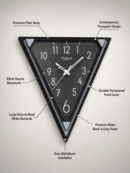 A triangular black wall clock with white numerals and hands, shown on a light gray background with callout lines and text describing its features.