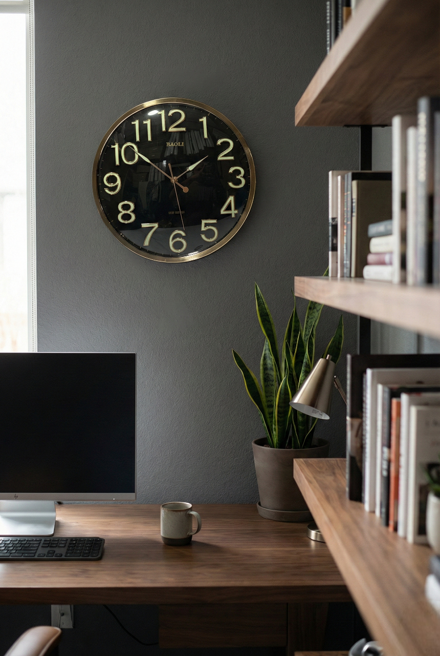 Modern home office with a desk, computer monitor, mug, plant, and wall clock.
