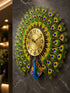Side perspective view of premium peacock wall clock showing layered metal feather design