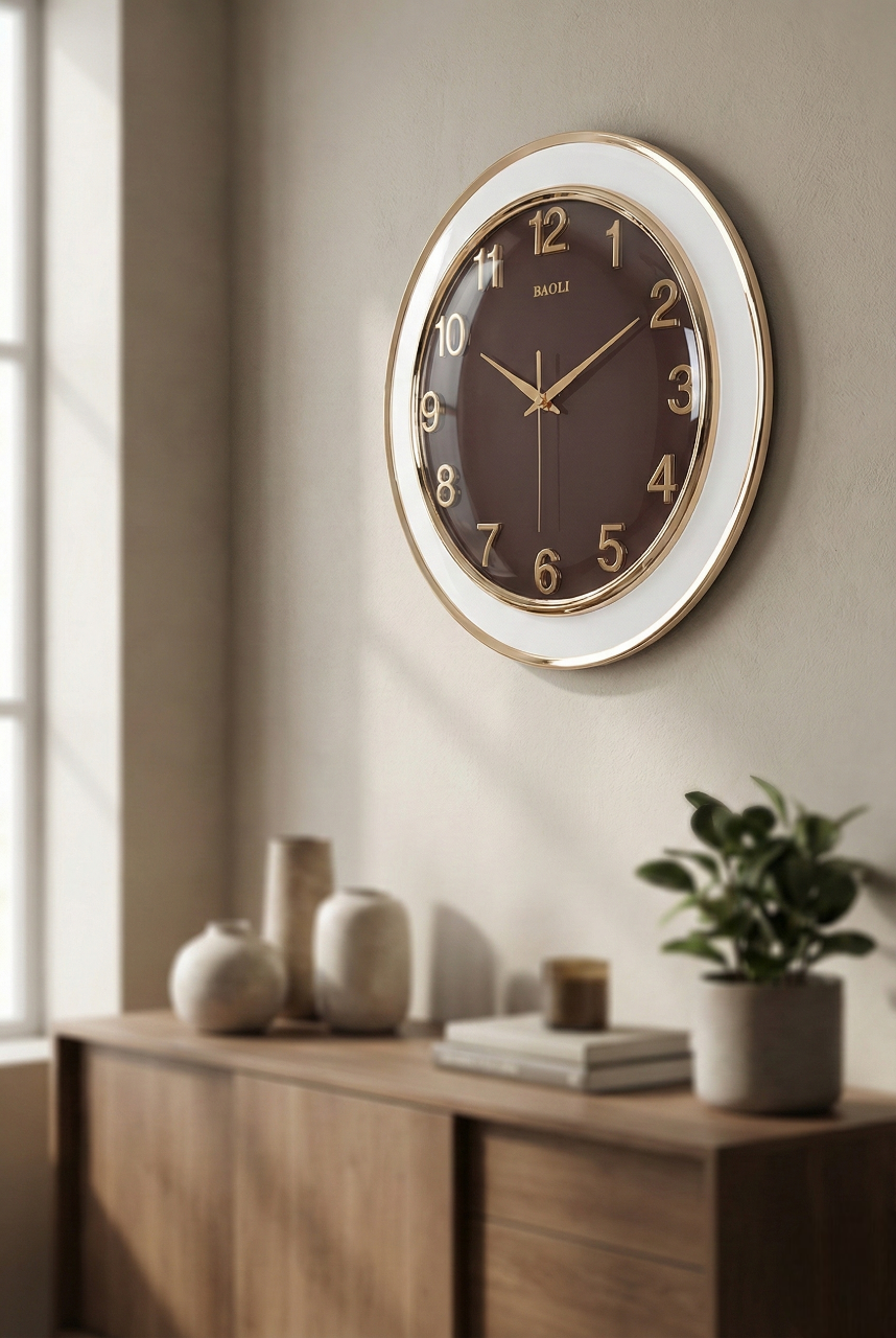 Wall clock on a wall above a wooden console table with decorative items.