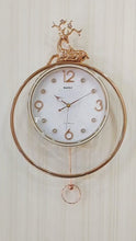 Load and play video in Gallery viewer, FunkyTradition Rose Gold White Reindeer Pendulum Wall Clock Wall Clock, Wall Decor for Home Office and Gifts 65 CM Tall
